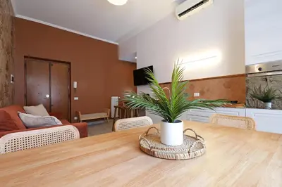 a living room with a table with a plant on it at Zelo Apartment by Nosdom Properties in Rome