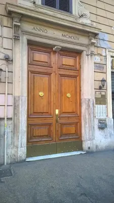 a large wooden door on the side of a building at A Casa Di Elle in Rome