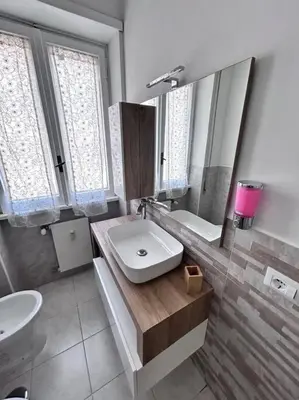 a bathroom with a sink and a mirror at Maison Monferrato in Rome
