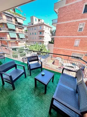 a balcony with four blue benches and a table at Maison Monferrato in Rome