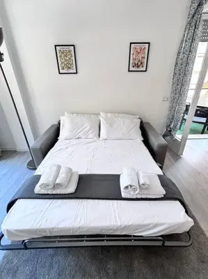 a bed in a bedroom with two towels on it at Maison Monferrato in Rome