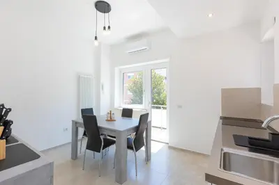 a kitchen with a table and chairs in a room at Baldo by Rental in Rome in Rome