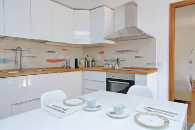 a white kitchen with a white table and chairs at Via dell'Orso Charme - My Extra Home in Rome