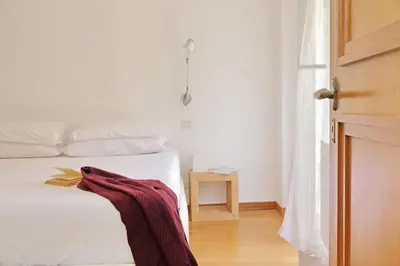a bedroom with a bed with a red blanket on it at Via dell'Orso Charme - My Extra Home in Rome