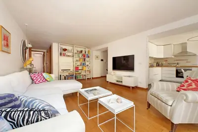 a living room with white furniture and a tv at Via dell'Orso Charme - My Extra Home in Rome