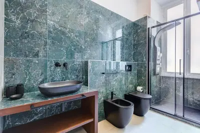a bathroom with a sink and a toilet at BMGA l Ottaviano Lux 3Bdr Apartment in Rome