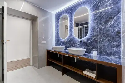 a bathroom with two sinks and a mirror at BMGA l Ottaviano Lux 3Bdr Apartment in Rome