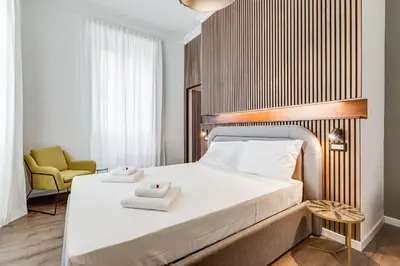a bedroom with a bed with two towels on it at BMGA l Ottaviano Lux 3Bdr Apartment in Rome