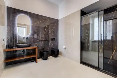 a bathroom with a sink and a mirror at BMGA l Ottaviano Lux 3Bdr Apartment in Rome
