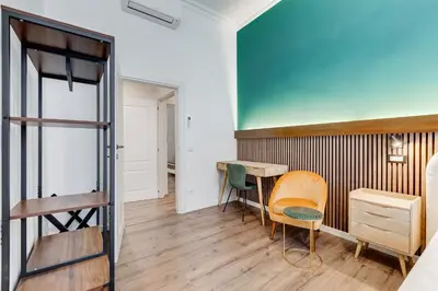 a room with a desk and a table and chairs at BMGA l Ottaviano Lux 3Bdr Apartment in Rome