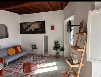 a living room with a blue couch and a tv at Navona Suite Rome - quite and view in Rome