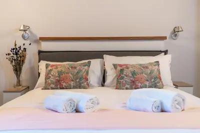 a bed with towels on top of it at Reginella Luxury Apartment in Rome