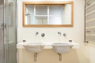 a bathroom with two sinks and a mirror at Reginella Luxury Apartment in Rome