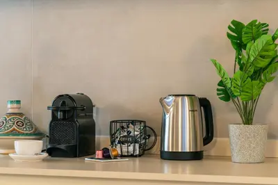 a counter top with a coffee maker and a coffee pot at Reginella Luxury Apartment in Rome