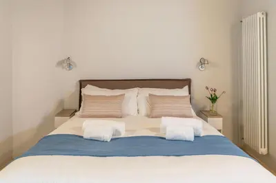 a bedroom with a bed with two pillows at Reginella Luxury Apartment in Rome