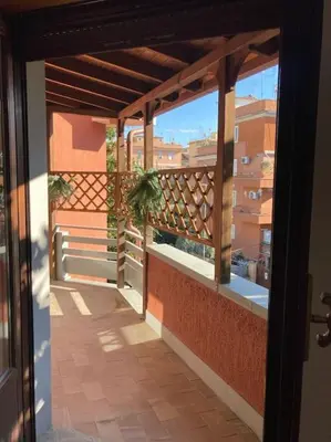 an open door to a balcony with a plant at Bellissimo Appartamento- metro Battistini - Vaticano - 120mq in Rome