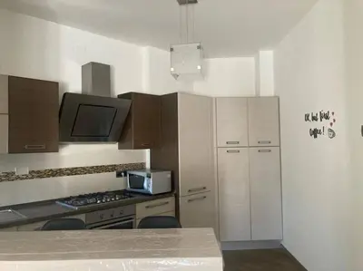a kitchen with a stove and a microwave at Bellissimo Appartamento- metro Battistini - Vaticano - 120mq in Rome