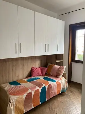 a bedroom with a bed with white cabinets at Bellissimo Appartamento- metro Battistini - Vaticano - 120mq in Rome
