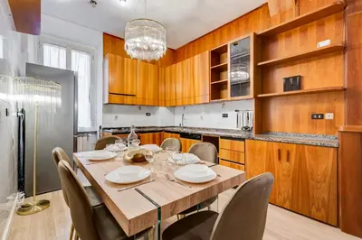 a dining room with a wooden table and chairs at NEW Vatican BIG apartment - ROMEDREAMHOME in Rome