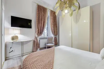 a white bedroom with a bed and a tv at NEW Vatican BIG apartment - ROMEDREAMHOME in Rome