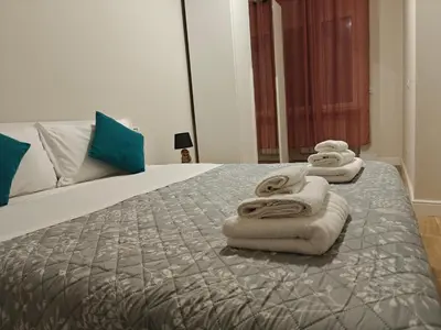 a bedroom with a bed with towels on it at Premium One-Bedroom Apartment plus sofa bed, Near Vatican - newly renovated in Rome