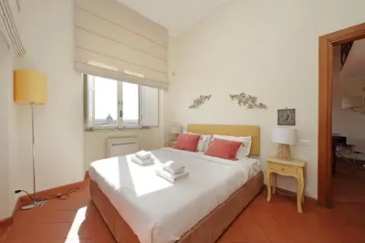 a bedroom with a large white bed with red pillows at Appartamento 