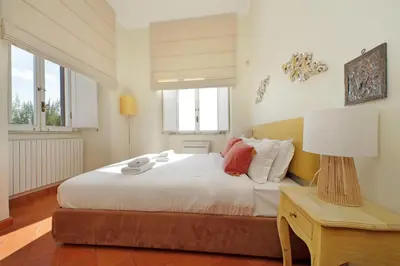 a bedroom with a bed and a table with a lamp at Appartamento 