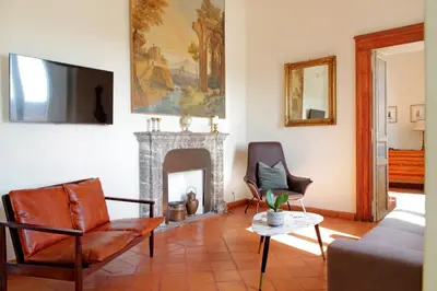 a living room with a couch and a fireplace at Appartamento 
