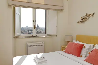 a bedroom with a bed with red pillows and a window at Appartamento 