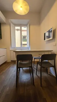 a room with two chairs and a table and a window at Greta's house in Rome