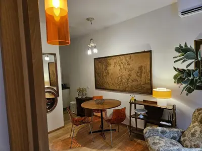 a living room with a table and chairs at Home Rome Borsieri in Rome