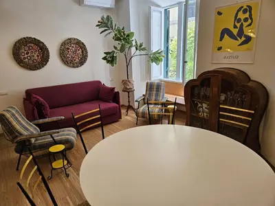 a living room with a white table and chairs at Home Rome Borsieri in Rome