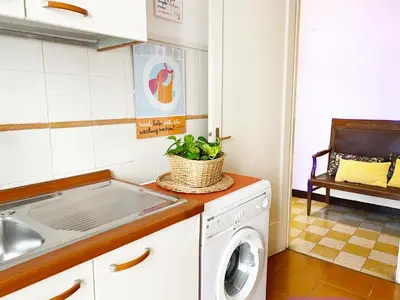 a kitchen with a washing machine and a sink at Appartamento tipico Romano - Rione XXII Apartment in Rome