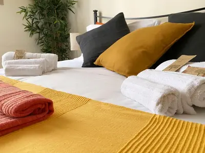 a bed with towels and pillows on top of it at Appartamento tipico Romano - Rione XXII Apartment in Rome