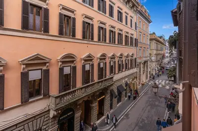 an empty street in a city with buildings at Townhouse Condotti 29 in Rome
