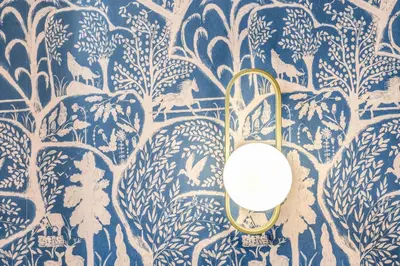 a room with a blue and white wall with a mirror at Townhouse Condotti 29 in Rome