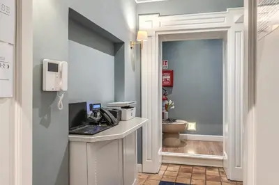 a bathroom with a phone and a laptop on a counter at Townhouse Condotti 29 in Rome