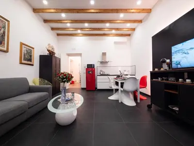 a living room with a couch and a table at ConTe Green House - 2 Apartments in Rome