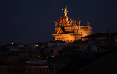 a lit up statue of liberty at night at ConTe Green House - 2 Apartments in Rome
