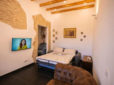 a room with a bed and a chair in it at ConTe Green House - 2 Apartments in Rome
