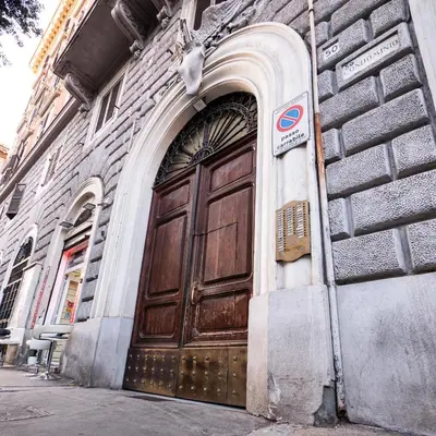 a wooden door on the side of a building at ConTe Green House - 2 Apartments in Rome