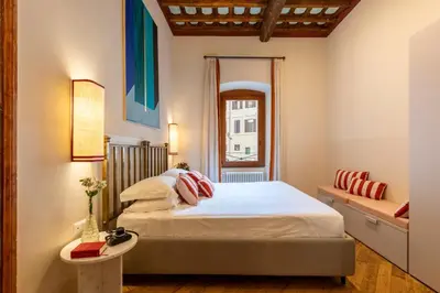a bedroom with a bed and a window at ROMAC Baullari IV Large apartment in Campo de' Fiori in Rome