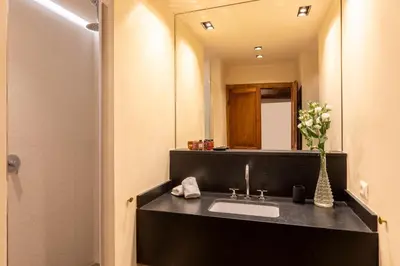 a bathroom with a sink and a mirror at ROMAC Baullari IV Large apartment in Campo de' Fiori in Rome