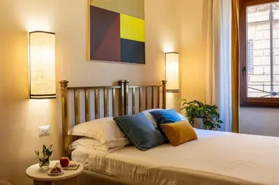 a bedroom with a bed with two pillows on it at ROMAC Baullari IV Large apartment in Campo de' Fiori in Rome
