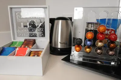 a kitchen counter with a coffee maker and a box at Suite Spagna 29 in Rome
