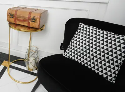 a black chair with a black and white pillow at Suite Spagna 29 in Rome