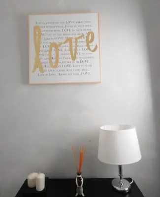 a lamp on a table with a picture on the wall at Suite Spagna 29 in Rome