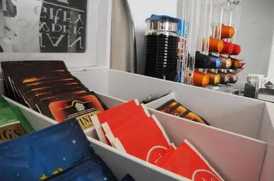 a white box filled with books and wine bottles at Suite Spagna 29 in Rome