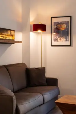 a living room with a couch and a lamp at Cavalieri Suites Roma in Rome