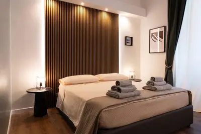 a bedroom with a bed with towels on it at Cavalieri Suites Roma in Rome